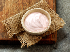 bowl of yogurt on wooden board 